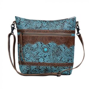 A blue shoulder bag with leather features