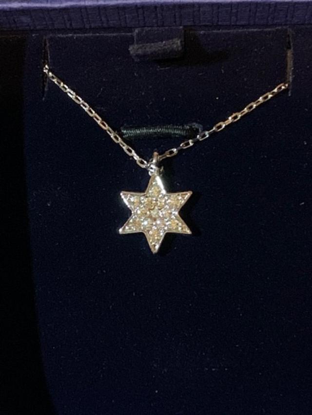 A star pendant of a jeweled necklace